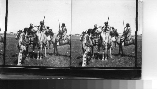 Groups of Indians on Sight [Side] Line between sham battles. Fort Belknap Reservation, Mont., July 1906