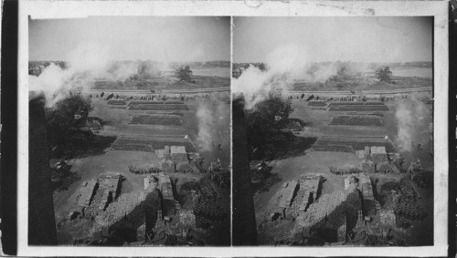 The yard from shed showing pipes for draining and Sewers in backyard. General View of a large brickyard. Portland, Maine