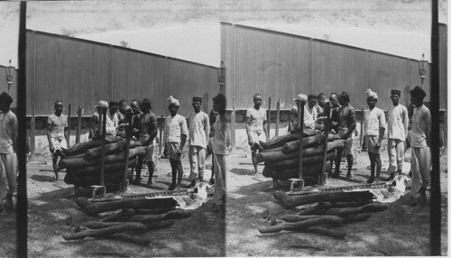 Relatives pouring the sacred water of the Ganges into the mouth of the dead before burning Bombay India