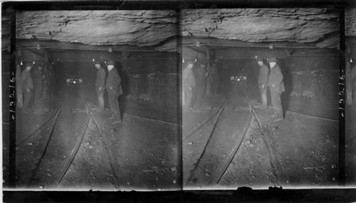 Group of miners in the main tunnel (1 1/2 mile long) of a huge coal mine