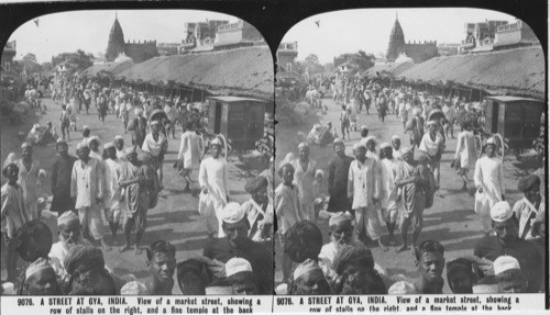 Inscribed in recto: 9076. A STREET AT GYA, INDIA. View of a market street, showing a row of stalls on the right, and a fine temple at the back