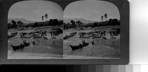 At the harbor of lake Nicaragua, largest lake between our Great Lakes and Bolivia's Lake Titicaca. Some of the smaller lake boats bringing cargo from its island and other points along its shores discharge by means of small boats. Bananas brought ashore to waiting trucks and rail cars have come from Ometepe Islands. Granada, Nicaragua, C.A