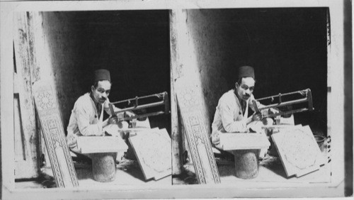 Egyptian mosaic artist at work in his Booth, Old Cairo