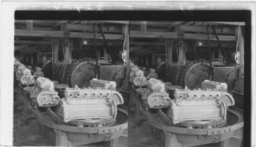 Motor Blocks coming from metal pouring process going to the "Tumbling" a process of cleansing and polishing the casting or motor block. The "Tumblings" are seen at right. Ford Motor Plant, Detroit, Mich. Fordson Tractor Motor Blocks Coming from Metal - Pouring Process on way to the "Tumbling Mill" , Detroit, Mich