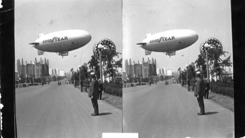 Goodyear Blimp Crossing the Street S. of and Transportation Bldg