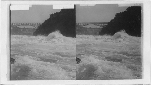 Looking up the Gorge of Niagara showing the Upper Arch Bridge and distant Falls. Niagara, N.Y