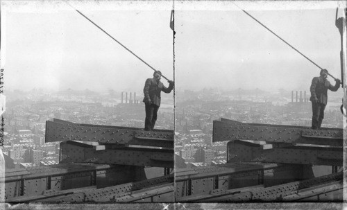 Steel Beams High in Air, About to Swing into Place; Metropolitan Tower