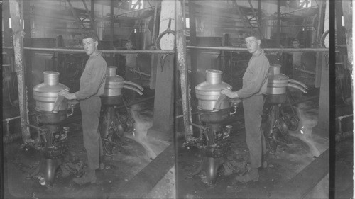 Cream separator in foreground and powder rolls in background. Wellington, Ont