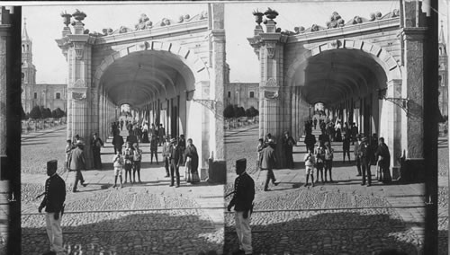 Townspeople coming and going through the Portal de Flores (Cathedral at left) Arequipa. Peru