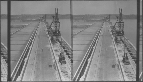 Noah over Dam--gives general view of Dam and power house- shows lock in distance and roadway in the foreground. Wilson Dam, Muscle Shoals, Ala