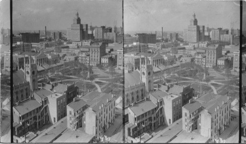 From Tower of St. Patrick Church on Camp St, looking a little west of North to City of New Orleans.* City Hall at lower left foreground, and Lafayette Square at right. Building with columns like a Greek temple