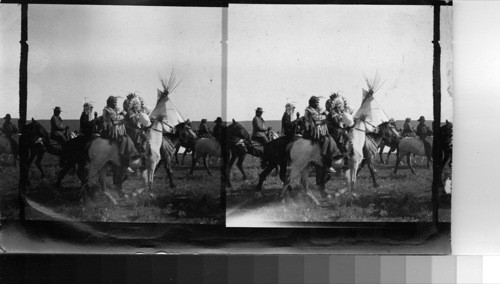 Indians riding about camp, urging all to Dress for, and participate in Sham Battle. Fort Belknap Reservation, Mont., July 1906