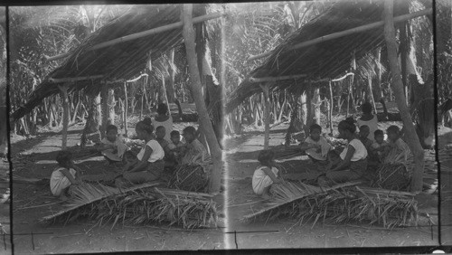 Women making nipa shingles from leaves of the nipa palm, P.I