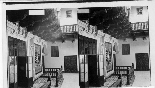 Rich mahogany carvings and mosaic floor in the patio, (court) of an old Spanish home. Lima, Peru