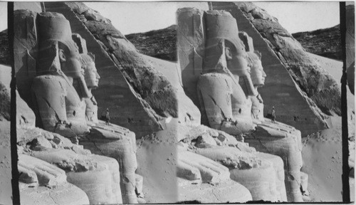 The Sixty-five foot portrait statues of Ramses II, before rock-lewn temple of Abu Simbel, Egypt