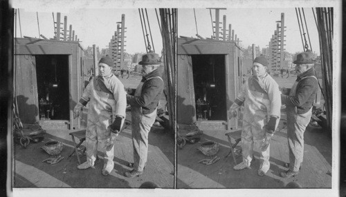 Govt. Diver pulling on his suit preparatory to a deep water dip. N.Y. City