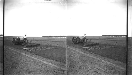 Manure Spreader followed by tractor plowing sod, near Omaha, Nebraska