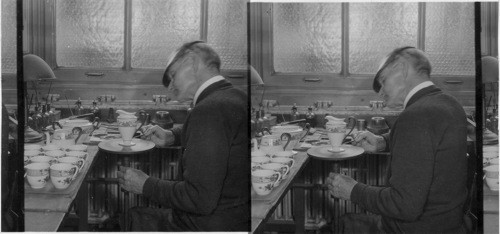 "Gilder" at work, applying gold decoration on a cream pitcher. "Lenox Inc." Makers of fine chinaware, Trenton, N.J