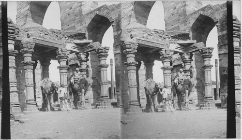 Colonnade in west end of old Mosque at Kutub Minar - Delhi, India. Iron Pillar at night