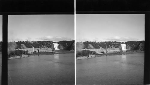 Montmorency Falls with the spinning mills and power plant operated by the falls. Prov. of Quebec. Canada