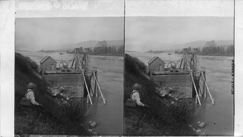 Washington. Fish Wheel, Columbia River, Washington Castle Rock. Oregon in Distance