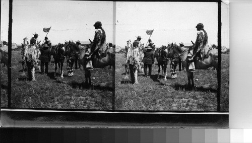 Groups of Indians on Sight [Side] Line between sham battles. Fort Belknap Reservation, Mont., July 1906