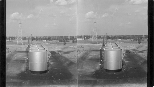 Separator Tanks and Active Wells near Kilgore, East Texas, World Renowned Oil Fields, City of Kilgore in distance