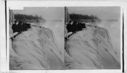 Winter halt conquers the mighty cataract - from Prospect Point over ice fringed Falls and River. Niagara Falls. New York