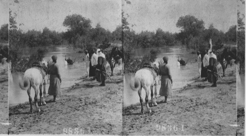 Baptizing in the Jordan. Palestine