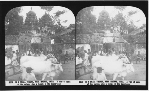 Inscribed in recto: 9059. IN A SMALL VILLAGE, NEAR MADRAS, INDIA. A view of some of the natives, also a temple in the background