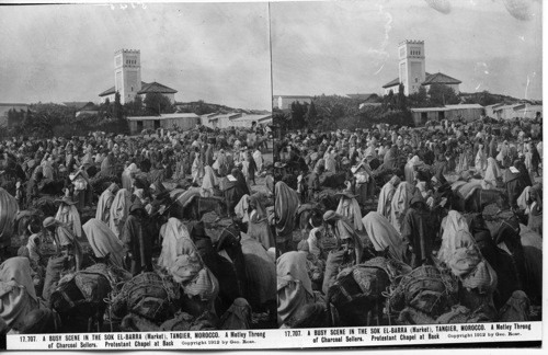 Inscribed in recto: 17,707. A BUSY SCENE IN THE SOK EL-BARRA (Market), TANGIER, MOROCCO. A Motley Throng of Charcoal Sellers. Protestant Chapel at Back. Copyright 1912 by Geo. Rose