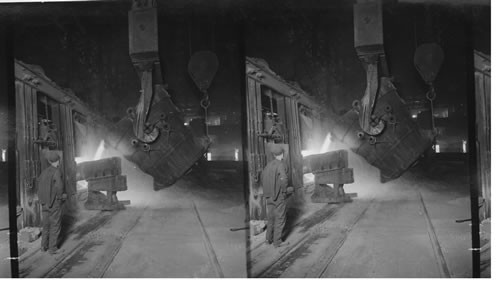 Pouring metal from great ladle into open hearth furnace/ Homestead, Penna