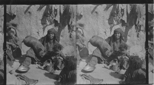 A Bedouin Woman of Palestine Churning with a Goat Skin