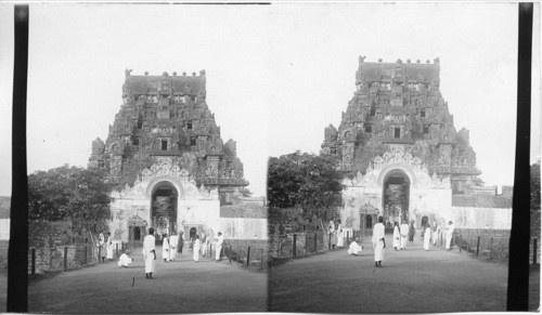 Guardian of Hindu mysteries - S.W. to gateway and sculptured temple tower Tanjore, India