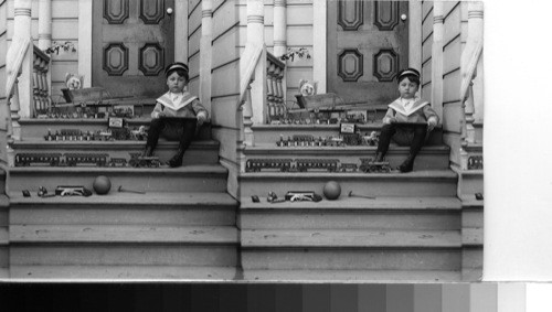 Playing all alone with his toys on the steps. California