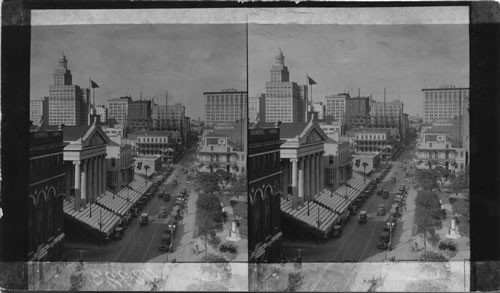 St. Charles Street showing City Hall Facing Lafayette Square, New Orleans, La. [Liberty Oil Company Sanders St. Charles Theatre "Liberty Pep a better gasoline"]