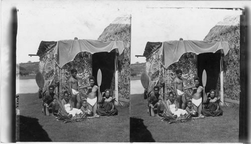 Group of natives eating poi in the old fashioned style - Hawaiian Islands