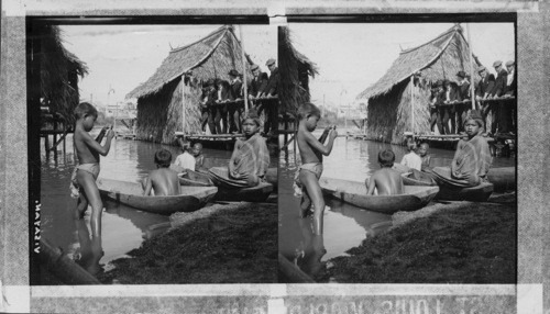 Young Visayan citizens and canoes on Shore of Arrow Head Lake. Philippine Village. St. Louis World's Fair