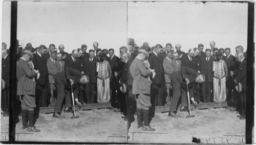 Pres. Harding placing the last spike which completes the Alaskan R.R. Sec'y Wallace back of Harding right leg. Alaska