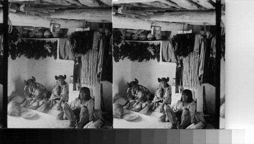 Hopi Indian Girls, showing peculiar method of dressing hair, grinding corn- Shonghopavi, Arizona