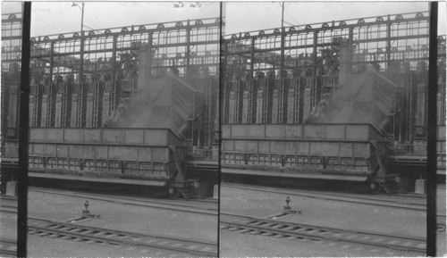 Coking being pushed out of Coke oven. Ford Motor Plant, Detroit, Mich