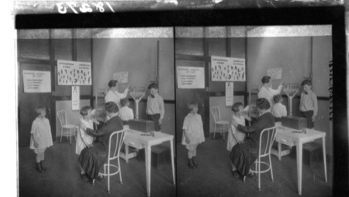 School doctor examining girl's throat, Chicago Ill