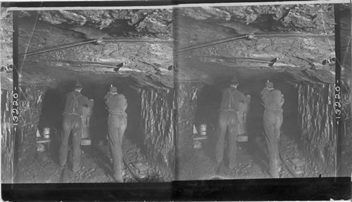 Miners pushing an "empty" (sides of tunnel show depth of coal vein). Coal Mine, Pittsburgh, Pa