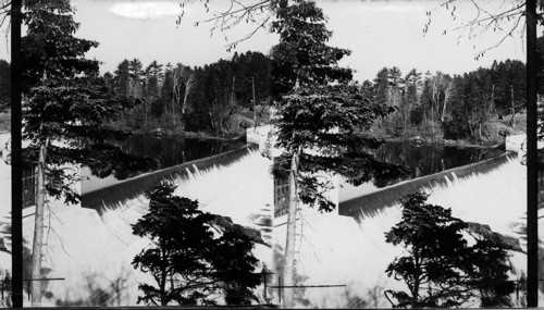 Dam built across (above) the Montmorency Falls to hold back the water and intake house, Province of Quebec, Canada