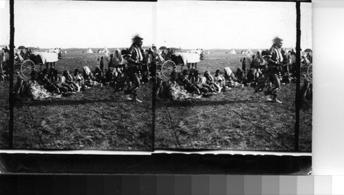 Grass Dancers in action. The Tom Tom beaters and singers being in the Shade of the Canopy. Fort Belknap Reservation, Mont., July 1906