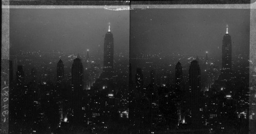 Candle-lighting Time in a Metropolis - - The Empire State Building at Night from Radio City Tower, New York City