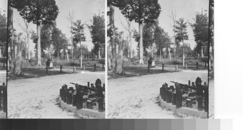 Northwest from center of Belleau Wood. Showing the unhealed scars of the battle. Memorial cross to the missing men in center of view. Relics of the battle in foreground. Battle relics and memorial cross to missing men, Belleau Wood. France. June '31 service
