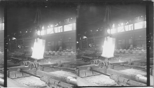 Lifting huge steel ingot from mold. Soaking pits and white hot ingot going to rolls, Structural Mill. Homestead, Penna