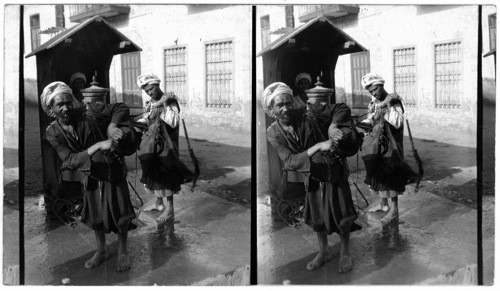 Street Sprinklers of Cairo filling their goat skins at a municipal hydrant Cairo