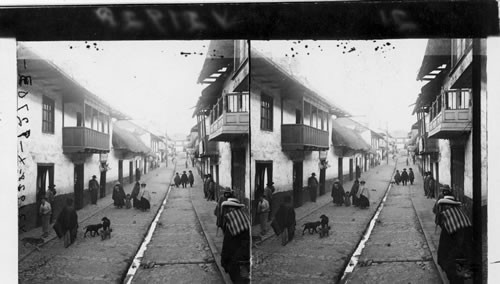 Everyday life in Cerro de Pasco - street lined with Spanish balconies and Indian roofs. Peru